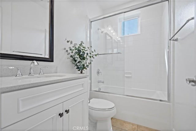 bathroom with toilet, tile patterned floors, shower / washtub combination, and vanity