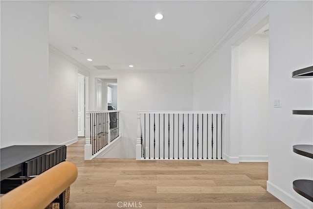 corridor with recessed lighting, crown molding, an upstairs landing, and wood finished floors