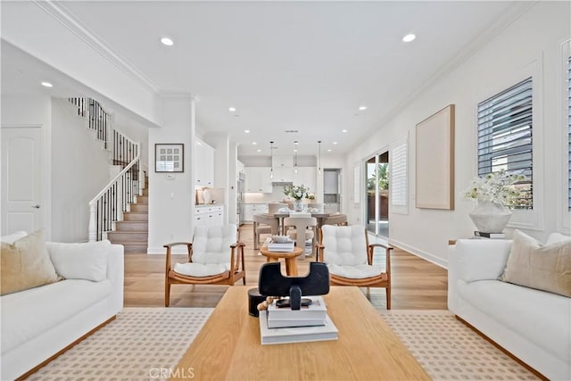 living area featuring recessed lighting, baseboards, stairs, light wood-style floors, and ornamental molding