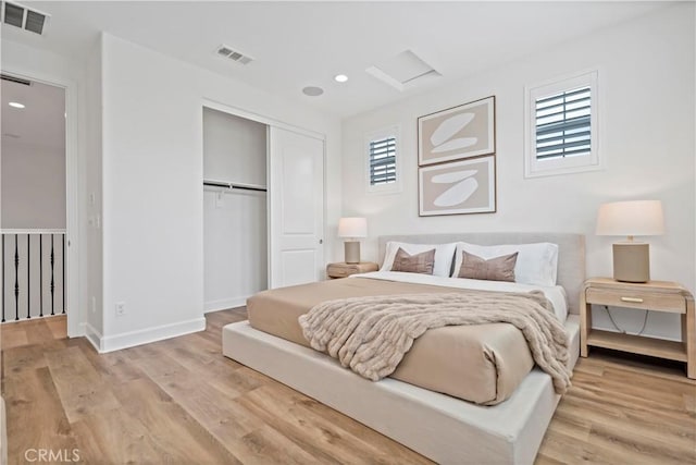 bedroom with visible vents, multiple windows, and a closet