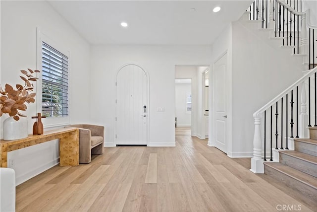 entrance foyer featuring recessed lighting, stairway, baseboards, and wood finished floors