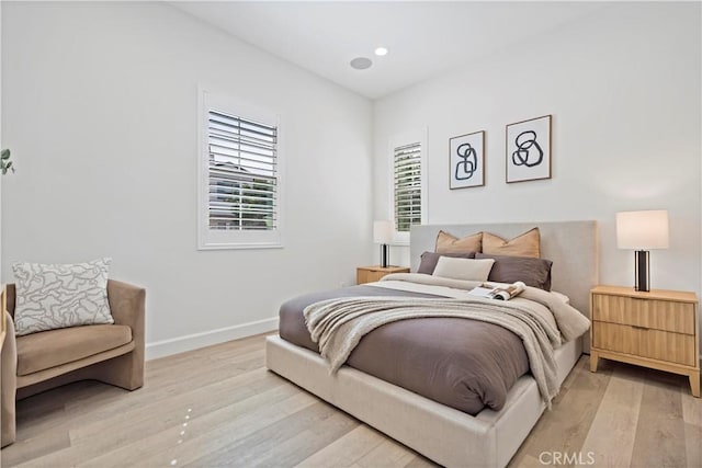 bedroom with recessed lighting, light wood-style flooring, and baseboards