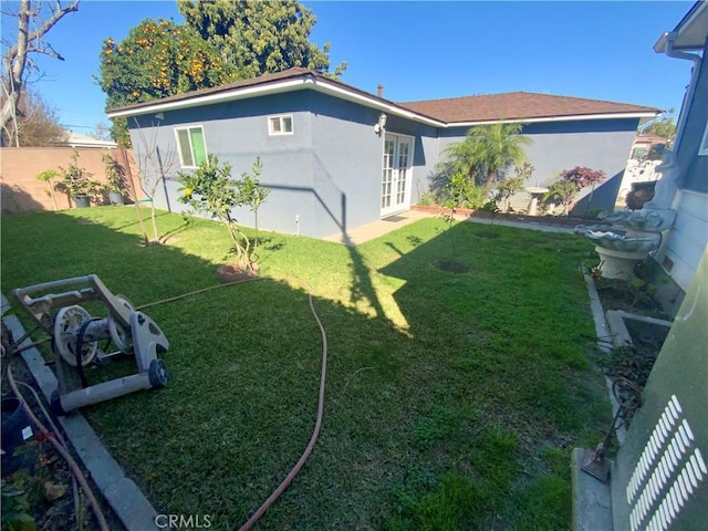 view of yard featuring french doors and a fenced backyard