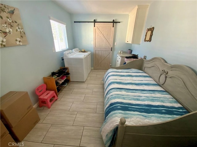 bedroom with a barn door and independent washer and dryer