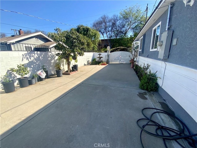 view of patio with fence private yard and a gate