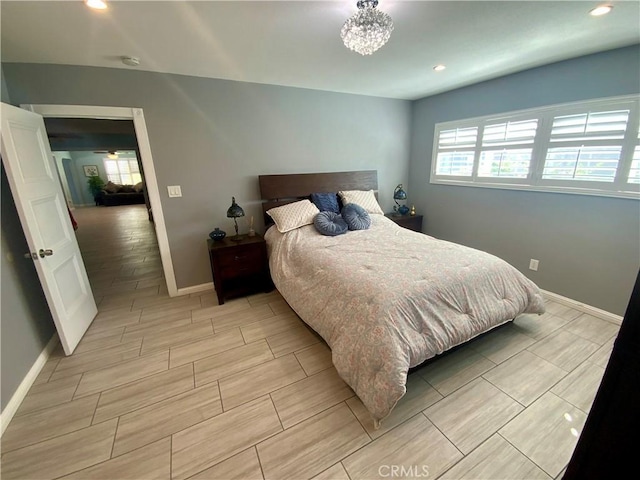 bedroom featuring a notable chandelier, recessed lighting, baseboards, and wood tiled floor
