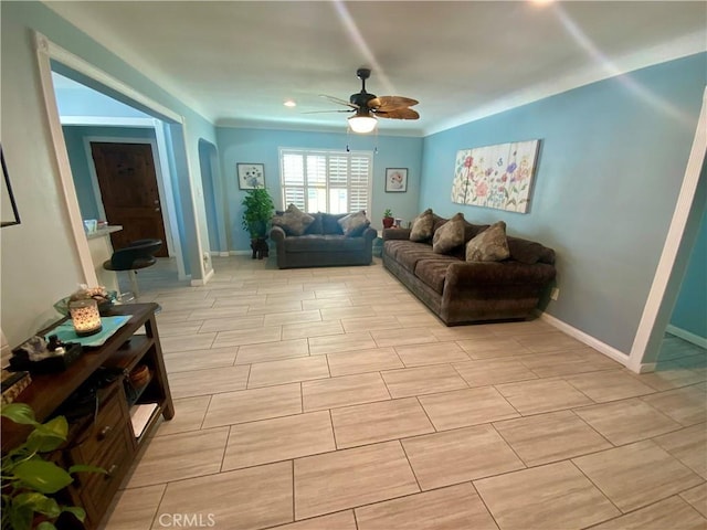 living room featuring baseboards and ceiling fan