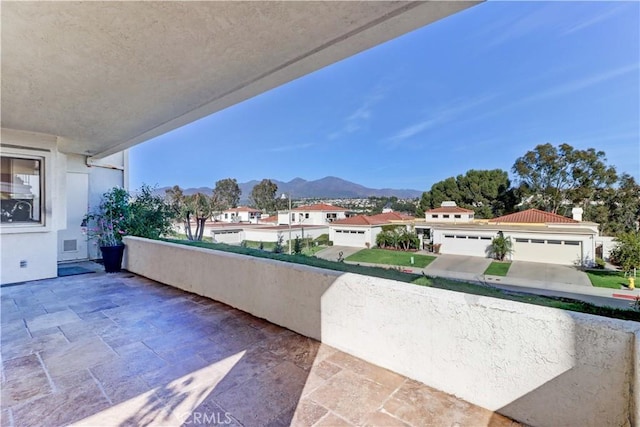 balcony with a residential view and a mountain view