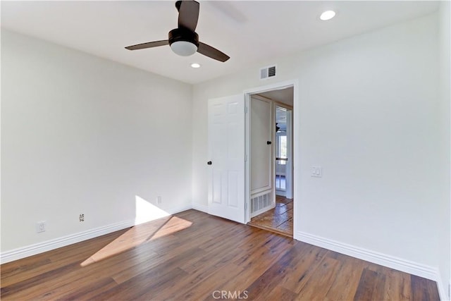 spare room with baseboards, visible vents, wood finished floors, and recessed lighting