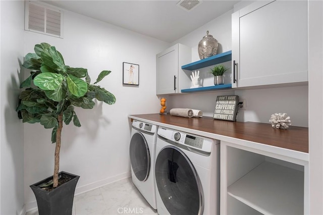 washroom featuring cabinet space, visible vents, separate washer and dryer, and marble finish floor