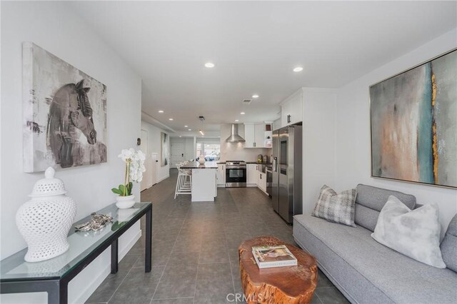 living room featuring dark tile patterned flooring and recessed lighting