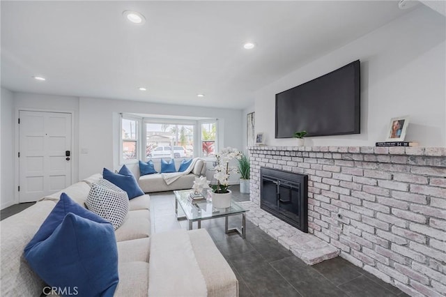 living area with a fireplace, baseboards, dark tile patterned flooring, and recessed lighting