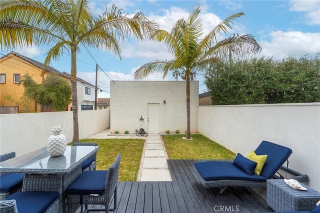 exterior space featuring a fenced backyard and a deck