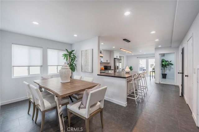 dining space featuring baseboards, dark tile patterned flooring, french doors, and recessed lighting