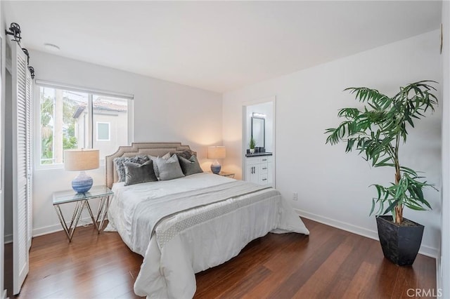 bedroom featuring dark wood-style flooring and baseboards