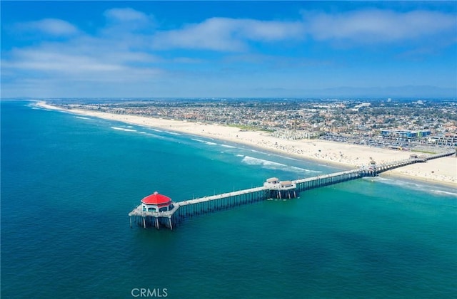 birds eye view of property with a beach view and a water view