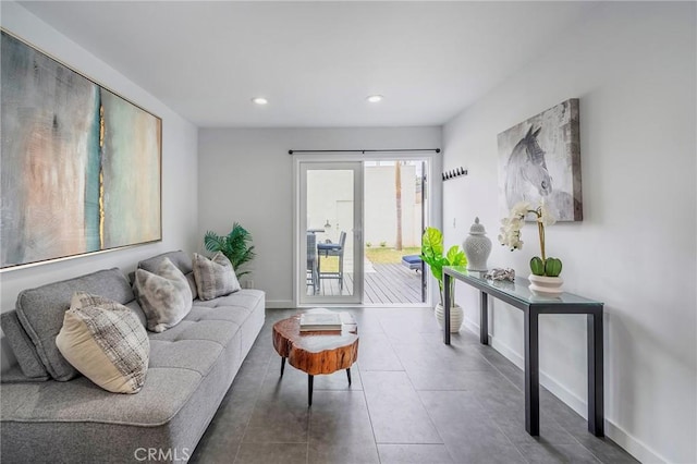 living room with recessed lighting, baseboards, and tile patterned floors