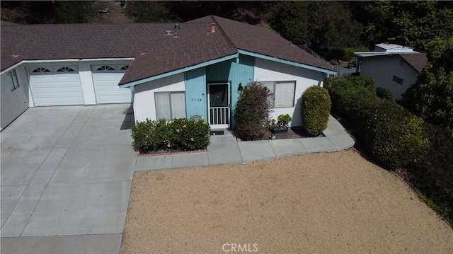 view of front of property with a garage and concrete driveway