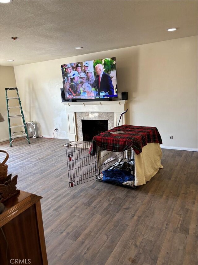 667 Canyon Crest Dr, Sierra Madre, CA 91024 - living area featuring wood finished floors, a premium fireplace, baseboards, recessed lighting, and a textured ceiling