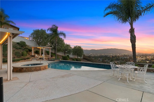 view of swimming pool with a patio area and a pool with connected hot tub