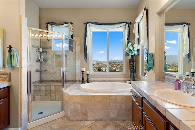 bathroom featuring tile patterned floors, a shower stall, vanity, and a bath