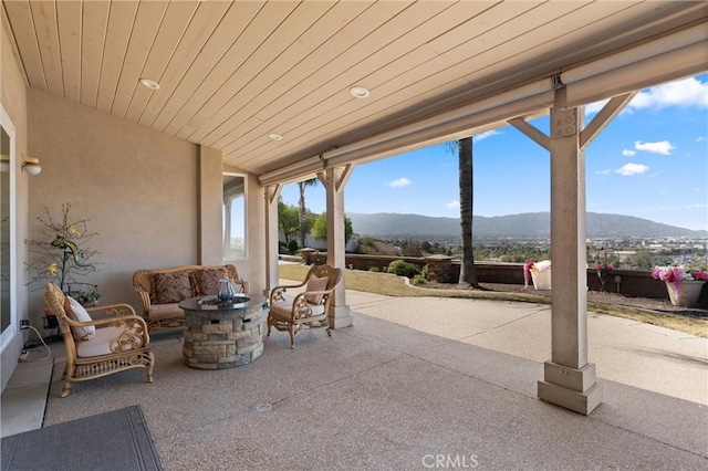 view of patio with outdoor lounge area and a mountain view