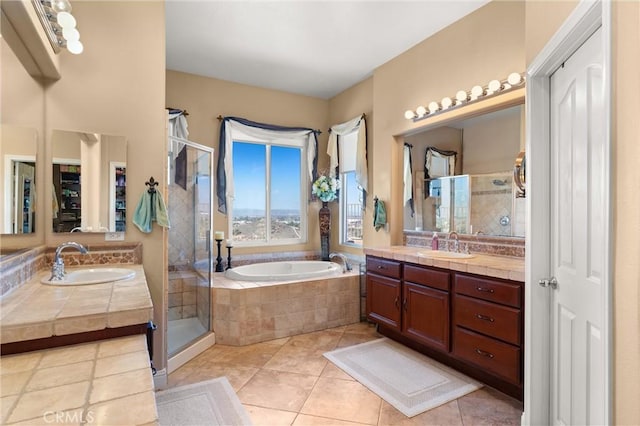 bathroom featuring a stall shower, two vanities, a sink, and a bath