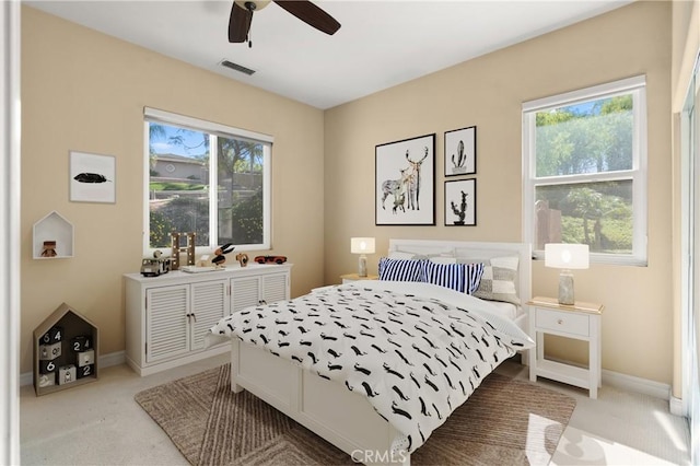 bedroom featuring light carpet, baseboards, visible vents, and ceiling fan