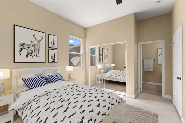 bedroom featuring ceiling fan, baseboards, and light colored carpet