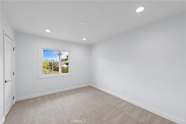unfurnished bedroom with recessed lighting, light colored carpet, and baseboards