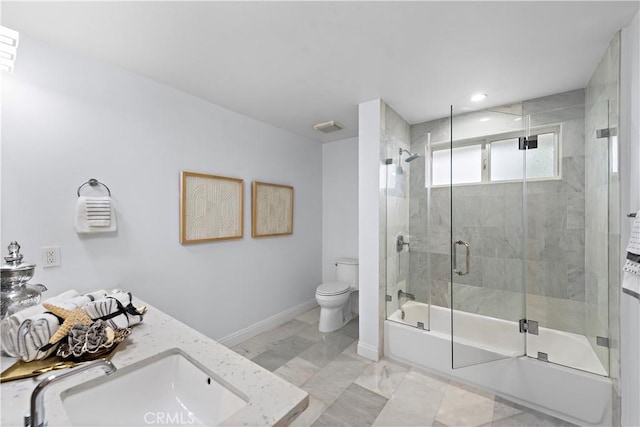 full bath featuring baseboards, a sink, toilet, shower / bath combination with glass door, and marble finish floor