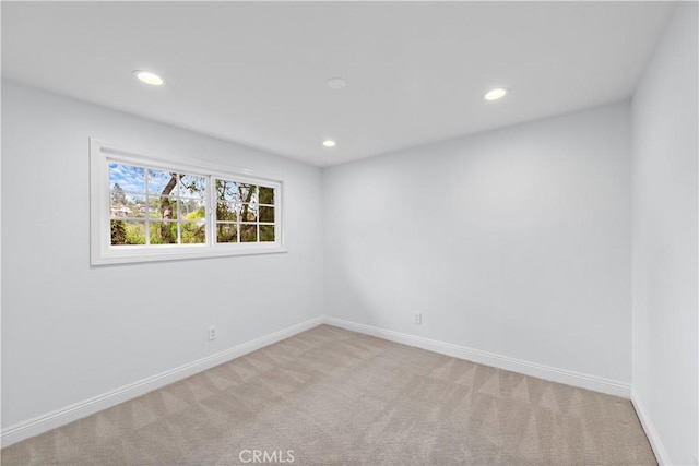 spare room featuring carpet floors, baseboards, and recessed lighting