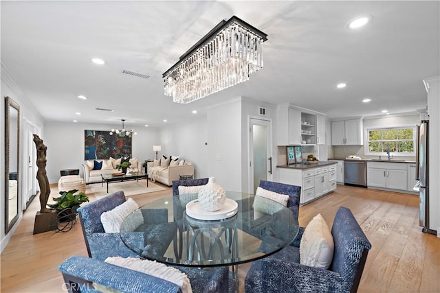 dining room featuring visible vents, light wood-style flooring, recessed lighting, and a chandelier