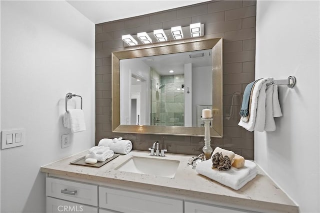 full bathroom with a shower stall and vanity