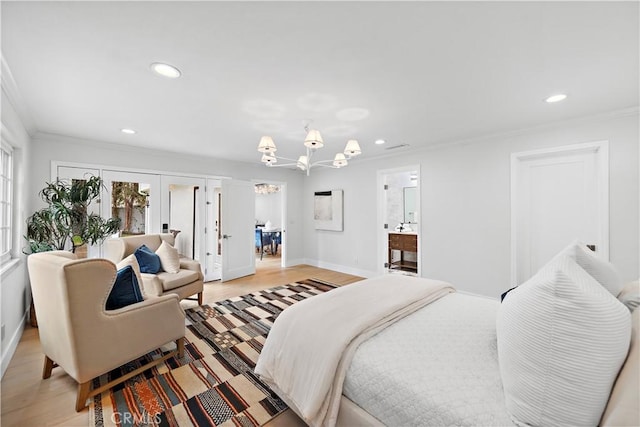 bedroom with french doors, an inviting chandelier, ornamental molding, and recessed lighting