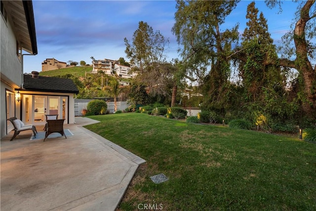 view of yard featuring fence and a patio