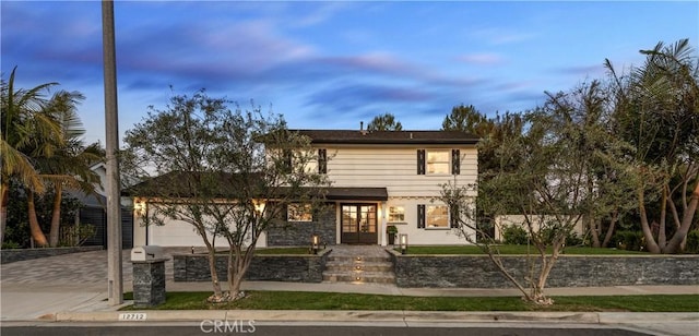 traditional-style home featuring an attached garage and concrete driveway