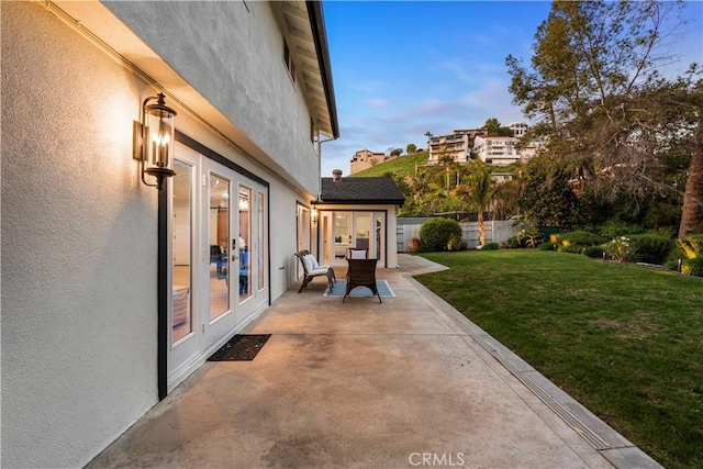 view of patio featuring french doors and fence