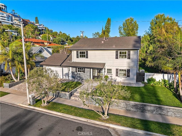 rear view of property with a yard and fence