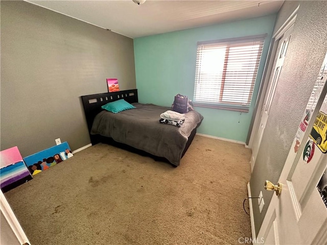 carpeted bedroom featuring baseboards