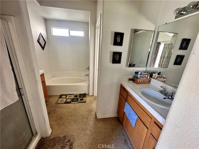 full bathroom featuring a bath, a stall shower, vanity, and baseboards