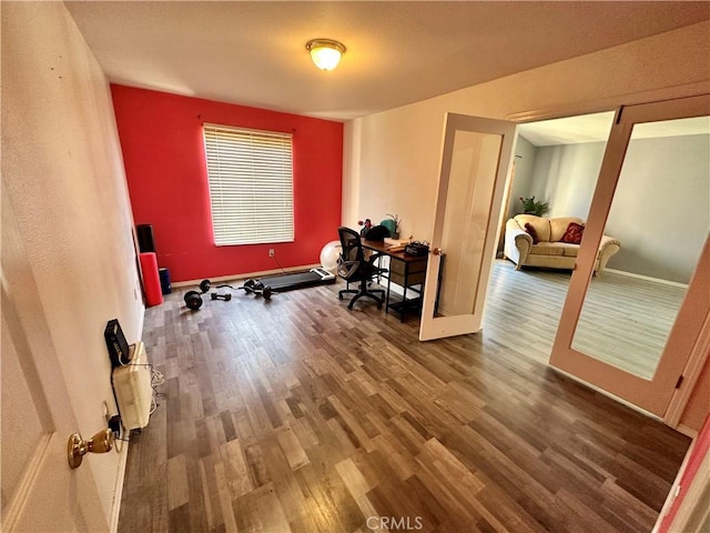 home office with french doors, baseboards, and wood finished floors