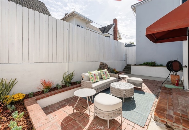 view of patio featuring an outdoor hangout area and a fenced backyard