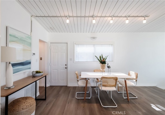 dining room with baseboards and dark wood-style flooring