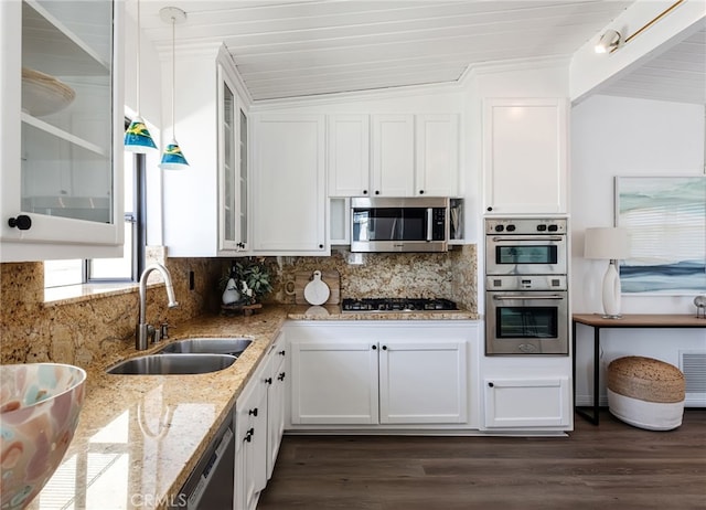 kitchen featuring a sink, tasteful backsplash, white cabinetry, and stainless steel appliances