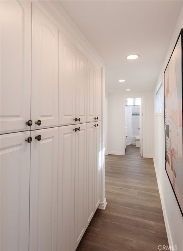 hall featuring recessed lighting, baseboards, and wood finished floors