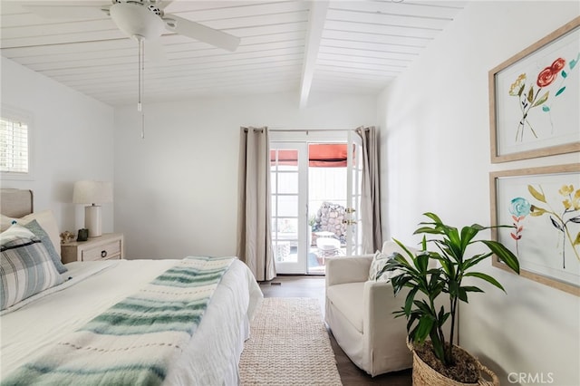 bedroom featuring multiple windows, wood finished floors, vaulted ceiling with beams, and ceiling fan