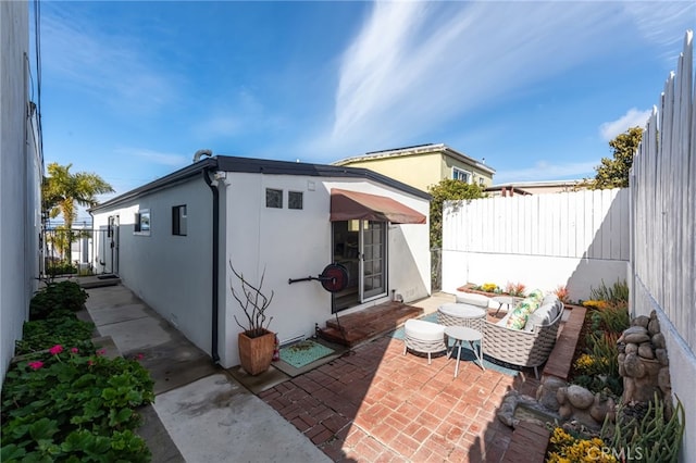 exterior space featuring stucco siding, a patio, and a fenced backyard