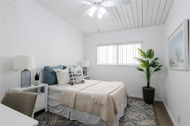 bedroom with ceiling fan, baseboards, wood finished floors, and wooden ceiling