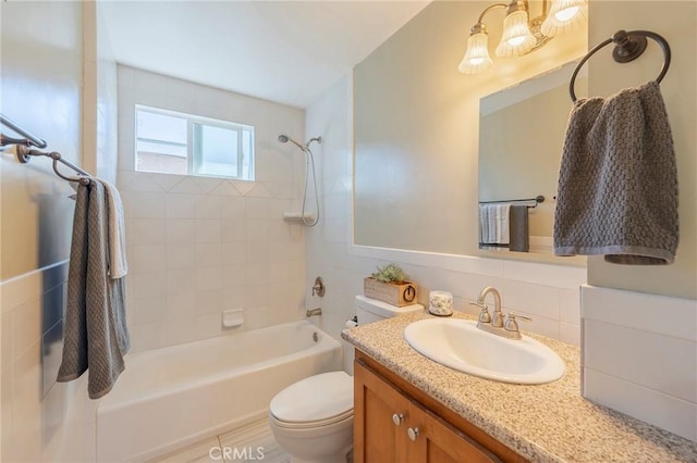 full bathroom with tub / shower combination, vanity, and toilet